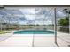 Enclosed pool and lanai area with putting green overlooking a lake provides a recreational space at 12026 Warwick Cir, Parrish, FL 34219