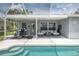 Covered lanai with seating, workout equipment, a grill, and a pool are perfect for entertaining at 12026 Warwick Cir, Parrish, FL 34219