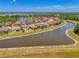 Panoramic aerial view of a residential community built around a serene lake, showcasing the community layout at 12315 Canavese Ln, Venice, FL 34293