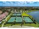 Aerial view of community tennis courts with lush landscaping and surrounding community at 12315 Canavese Ln, Venice, FL 34293