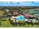 Aerial view of community clubhouse, pool, tennis courts, and spa at 12315 Canavese Ln, Venice, FL 34293