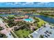 Aerial view of community clubhouse, pool, tennis courts, and parking at 12315 Canavese Ln, Venice, FL 34293