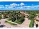 Aerial view of community clubhouse entrance with manicured landscaping and palms at 12315 Canavese Ln, Venice, FL 34293