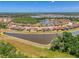 Aerial view of a lakeside community with single-Gathering homes with red roofs at 12315 Canavese Ln, Venice, FL 34293