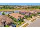Aerial view of the properties showcasing landscaping and views of the pond at 12315 Canavese Ln, Venice, FL 34293