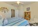 Comfortable bedroom with a recliner, a queen bed, and warm lighting, perfect for relaxation at 12315 Canavese Ln, Venice, FL 34293