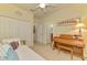 Cozy bedroom featuring twin bed, white walls, and natural light with adjoining bathroom and closet entrances at 12315 Canavese Ln, Venice, FL 34293
