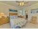 Comfortable bedroom showcasing coastal-themed decor, a bamboo bed frame, and ample natural light at 12315 Canavese Ln, Venice, FL 34293