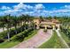 A grand entrance showcasing lush greenery, stately architecture, and manicured grounds create a welcoming impression at 12315 Canavese Ln, Venice, FL 34293