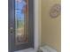 Elegant front door with decorative glass, digital lock and sunflower mosaic on an attractive stucco wall at 12315 Canavese Ln, Venice, FL 34293