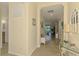 Open hallway featuring tile floors, neutral colored walls, and a glimpse into the bright living area at 12315 Canavese Ln, Venice, FL 34293
