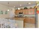 Kitchen island has granite countertops, pendant lighting, and seating at 12315 Canavese Ln, Venice, FL 34293