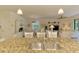 Kitchen with granite countertops and stainless steel appliances, with view to the living room at 12315 Canavese Ln, Venice, FL 34293