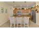 Kitchen island features a bar and overhead pendant lighting at 12315 Canavese Ln, Venice, FL 34293