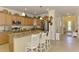 Kitchen island offers granite countertops, stainless steel appliances, and seating at 12315 Canavese Ln, Venice, FL 34293