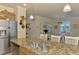 Kitchen island with stainless steel sink, granite countertops and stainless steel appliances at 12315 Canavese Ln, Venice, FL 34293