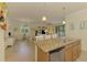 Open concept kitchen with granite countertops, stainless steel appliances, and views into the dining and living areas at 12315 Canavese Ln, Venice, FL 34293