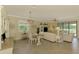 Bright living area with tile floors, a dining area and views of the screened in lanai at 12315 Canavese Ln, Venice, FL 34293