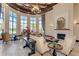 Bright living room features high ceilings, fireplace, elegant furniture, and pool views through large windows at 12315 Canavese Ln, Venice, FL 34293