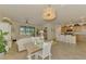 Open concept living area features a dining space, seating, and kitchen with island seating at 12315 Canavese Ln, Venice, FL 34293