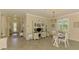 Spacious living area featuring tile flooring, neutral walls, and a glimpse of the entry and kitchen at 12315 Canavese Ln, Venice, FL 34293