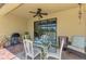 Inviting covered patio with dining and lounging areas, providing serene views of the peaceful pond at 12315 Canavese Ln, Venice, FL 34293