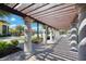 View of the community pool and building through a colonnade featuring manicured landscaping at 12315 Canavese Ln, Venice, FL 34293