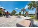 Poolside patio featuring lounge chairs, dining tables, and views of the lake at 12315 Canavese Ln, Venice, FL 34293