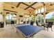 Bright recreation room featuring a ping pong table, fireplace, and comfortable seating area for leisure activities at 12315 Canavese Ln, Venice, FL 34293