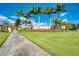 Gran Paradiso's entrance sign, framed by vibrant landscaping and palm trees, welcomes residents and visitors at 12315 Canavese Ln, Venice, FL 34293