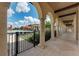 Walkway with an arched colonnade offering views of the pool, patio, and community center at 12315 Canavese Ln, Venice, FL 34293