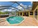 Aerial view of backyard with a screened-in pool, hot tub, and outdoor seating area at 127 Mill E Run, Bradenton, FL 34212