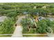 Aerial view showcases a home near a pond, highlighting the landscaped yard and solar panels at 127 Mill E Run, Bradenton, FL 34212