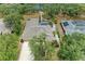 Aerial perspective features a home with mature trees, a screened pool and manicured landscape at 127 Mill E Run, Bradenton, FL 34212