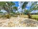 Spacious stone patio with path to house and lush backyard at 127 Mill E Run, Bradenton, FL 34212