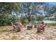 Stone patio with outdoor seating arrangement and fire pit overlooking a beautiful lake at 127 Mill E Run, Bradenton, FL 34212