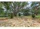Stone patio overlooking a scenic lake with mature trees and lush greenery at 127 Mill E Run, Bradenton, FL 34212