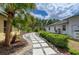 A backyard featuring pavers, lush landscaping, and a well-maintained lawn at 127 Mill E Run, Bradenton, FL 34212
