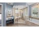 Bathroom featuring a walk-in shower with bench, tub, and vanity area at 127 Mill E Run, Bradenton, FL 34212