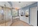 Bathroom features a walk-in shower, soaking tub, double vanities, and decorative chandelier at 127 Mill E Run, Bradenton, FL 34212