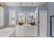 Bathroom with double sinks, tiled bathtub, and walk-in shower with glass doors at 127 Mill E Run, Bradenton, FL 34212
