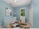 Light and airy Bedroom featuring a white crib, dresser, and playful decor, perfect for a cozy space at 127 Mill E Run, Bradenton, FL 34212