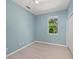 An empty bedroom featuring a light blue wall paint, light hardwood flooring, and a built-in closet at 127 Mill E Run, Bradenton, FL 34212