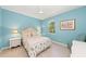 Cozy bedroom with blue walls, decorative bed, and natural lighting at 127 Mill E Run, Bradenton, FL 34212