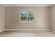 Bedroom featuring light floors and a window that looks out into the beautiful, green scenery at 127 Mill E Run, Bradenton, FL 34212