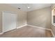A simplistic bedroom with light wood floors, a ceiling fan, and a large closet for ample storage at 127 Mill E Run, Bradenton, FL 34212