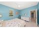 Coastal-themed bedroom with seashell bedding, dresser, and a ceiling fan at 127 Mill E Run, Bradenton, FL 34212