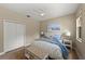 Comfortable bedroom featuring neutral walls, ceiling fan, and a cozy bed with a cushioned bench at 127 Mill E Run, Bradenton, FL 34212
