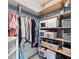 Organized walk-in closet with shelves, rods, drawers, and storage containers at 127 Mill E Run, Bradenton, FL 34212