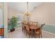 A dining room featuring a chandelier, hardwood floors, and large window that provides great natural light at 127 Mill E Run, Bradenton, FL 34212